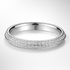 Platinum wedding ring with diamond accents on a light grey background