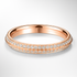 Rose gold wedding ring with diamond accents on a light grey background