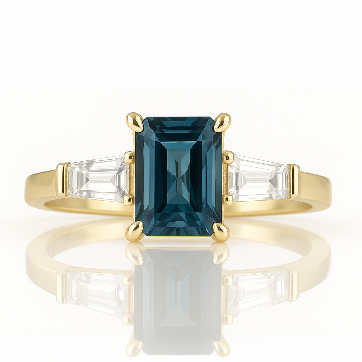 Gold ring with a blue gemstone and clear stones on a white background