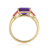 Gold ring with a purple gemstone and red side stones on a white background
