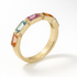 Gold ring with multicolored gemstones on a white background