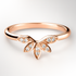 Rose gold ring with diamond accents on a light grey background
