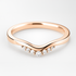 Rose gold ring with diamond accents on a light background