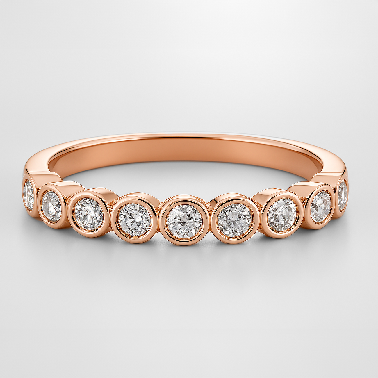 Rose Gold Rubover Setting Diamond Wedding Ring on a White Background