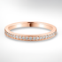 Rose gold ring with diamonds on a light grey background