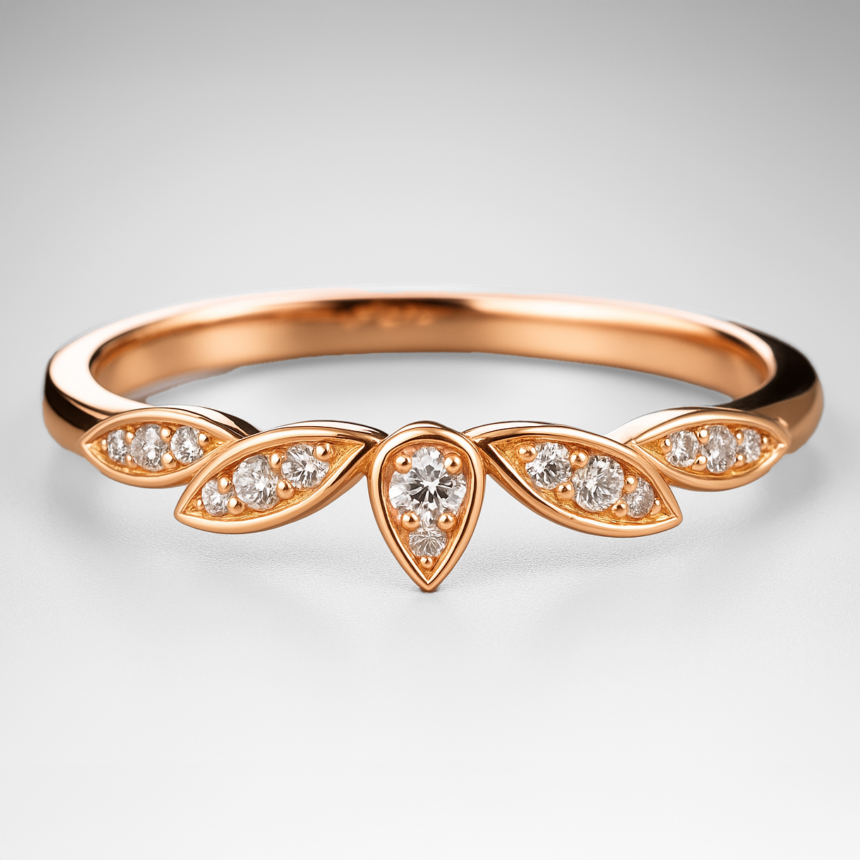 Rose gold ring with diamond accents on a light grey background