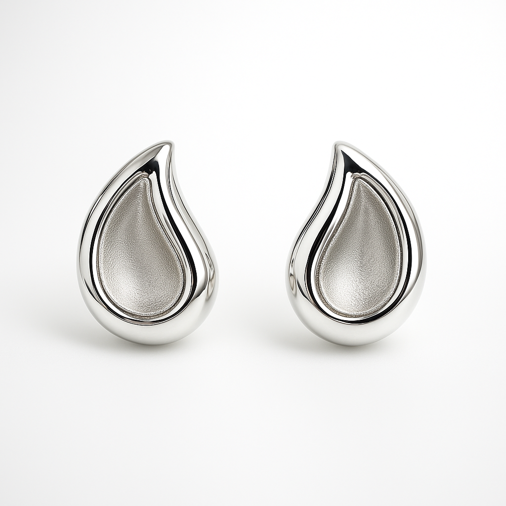 Pair of silver teardrop-shaped earrings on a white background