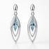 Silver earrings with blue gemstones on a white background