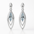 Silver earrings with blue gemstones on a white background