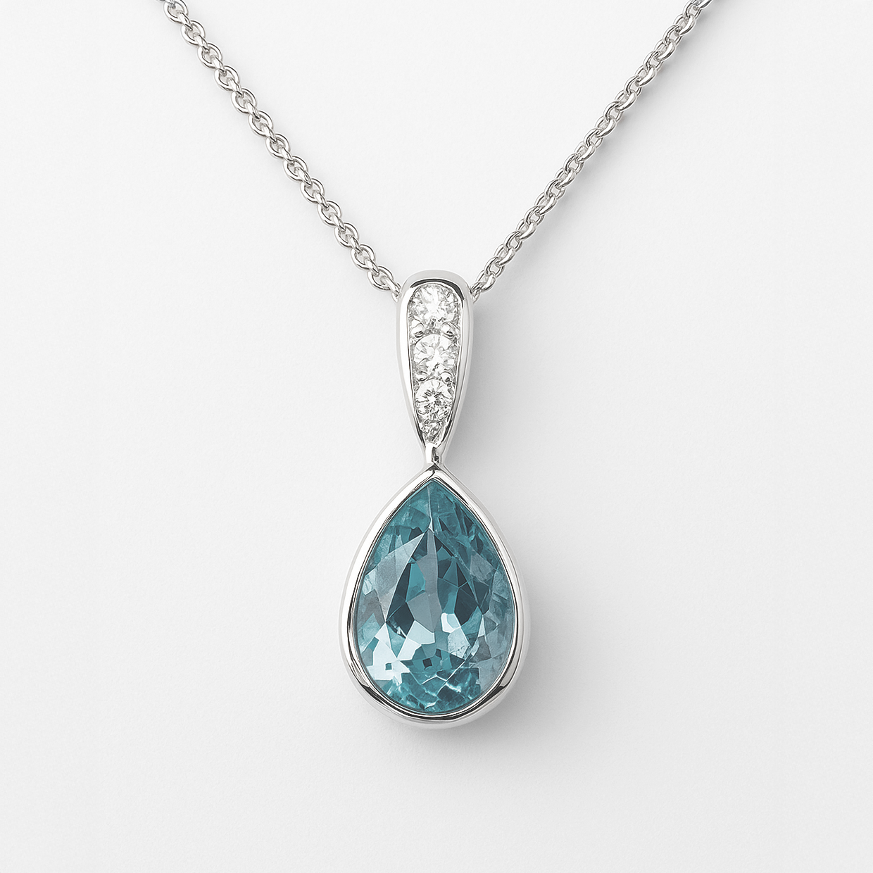 Teardrop-shaped blue gemstone pendant with white stone accents on a white background