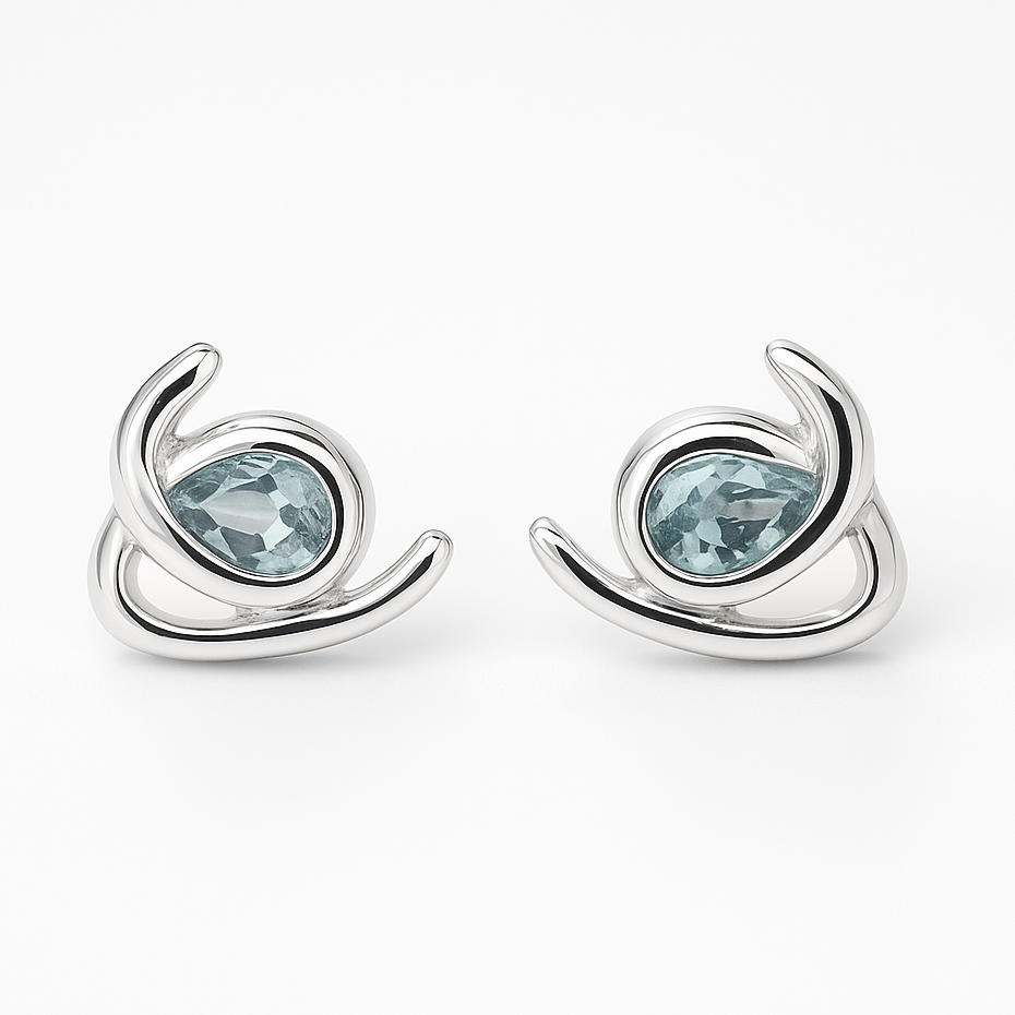 Silver earrings with blue gemstones on a white background