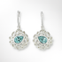 Pair of silver earrings with blue gemstones on a white background