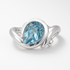 Silver ring with a blue gemstone on a white background