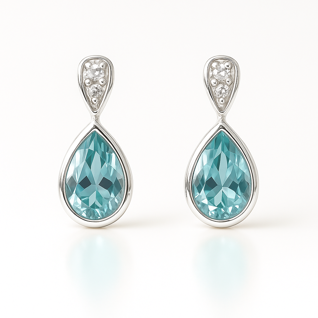Teardrop-shaped earrings with blue gemstones and silver accents on a white background