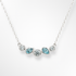 Necklace with blue and clear gemstones on a white background