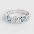 Silver ring with blue gemstones on a light grey background