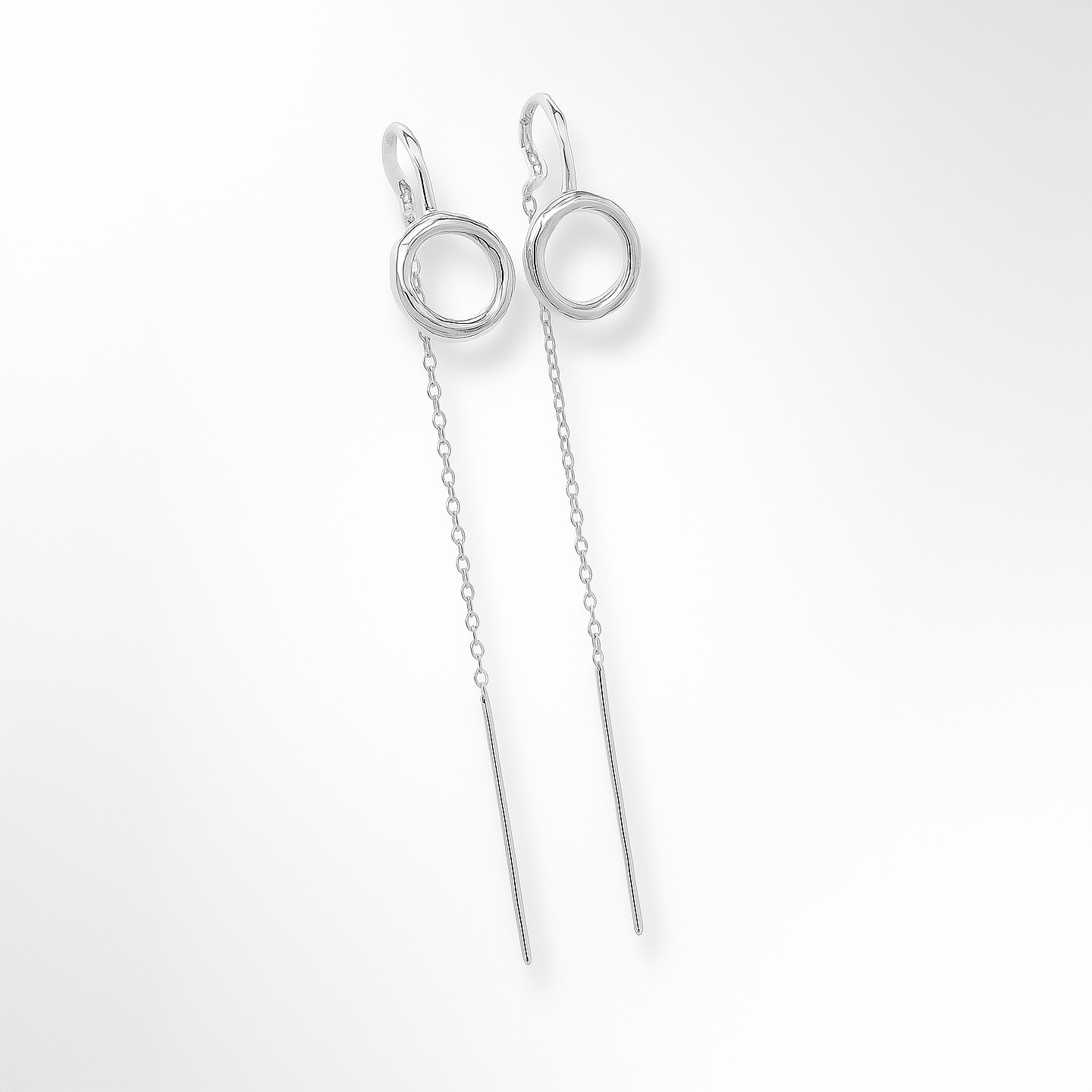 Silver earrings with long chains on a white background