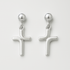 Pair of silver cross-shaped earrings on a light gray background