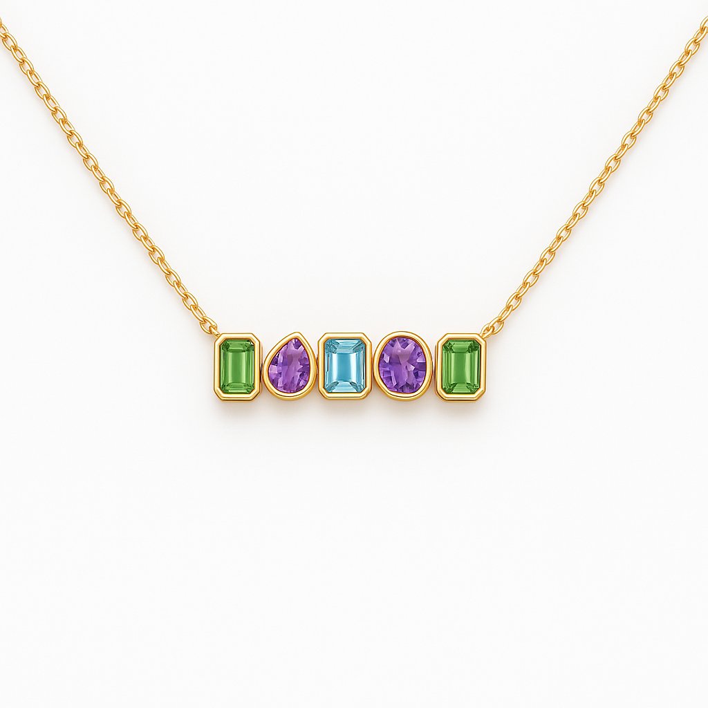 Gold necklace with five colored gemstones on a white background
