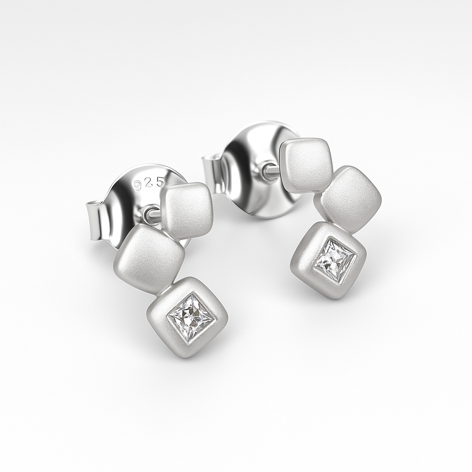 Silver earrings with square stones on a white background