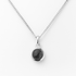 Silver necklace with a black gemstone pendant on a white background