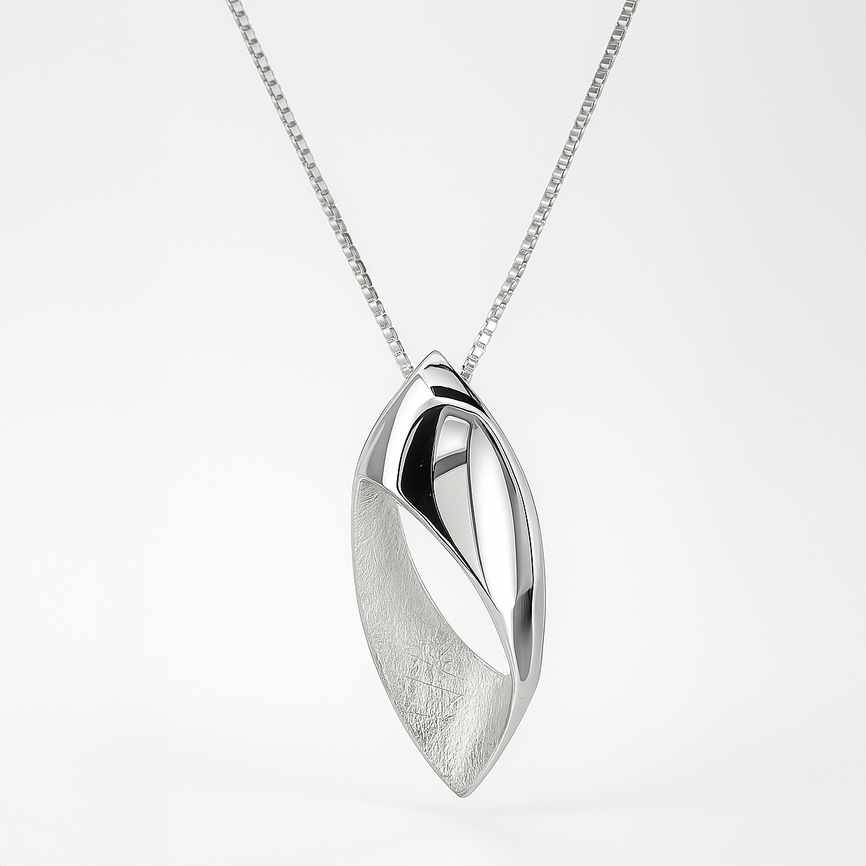Silver pendant necklace on a light gray background