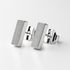 Pair of silver rectangular stud earrings on a light grey background