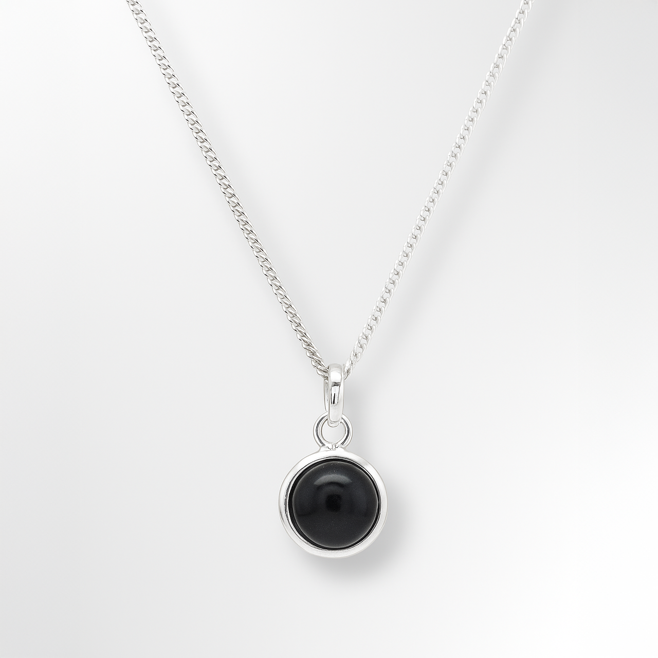 Necklace with a black pendant on a white background