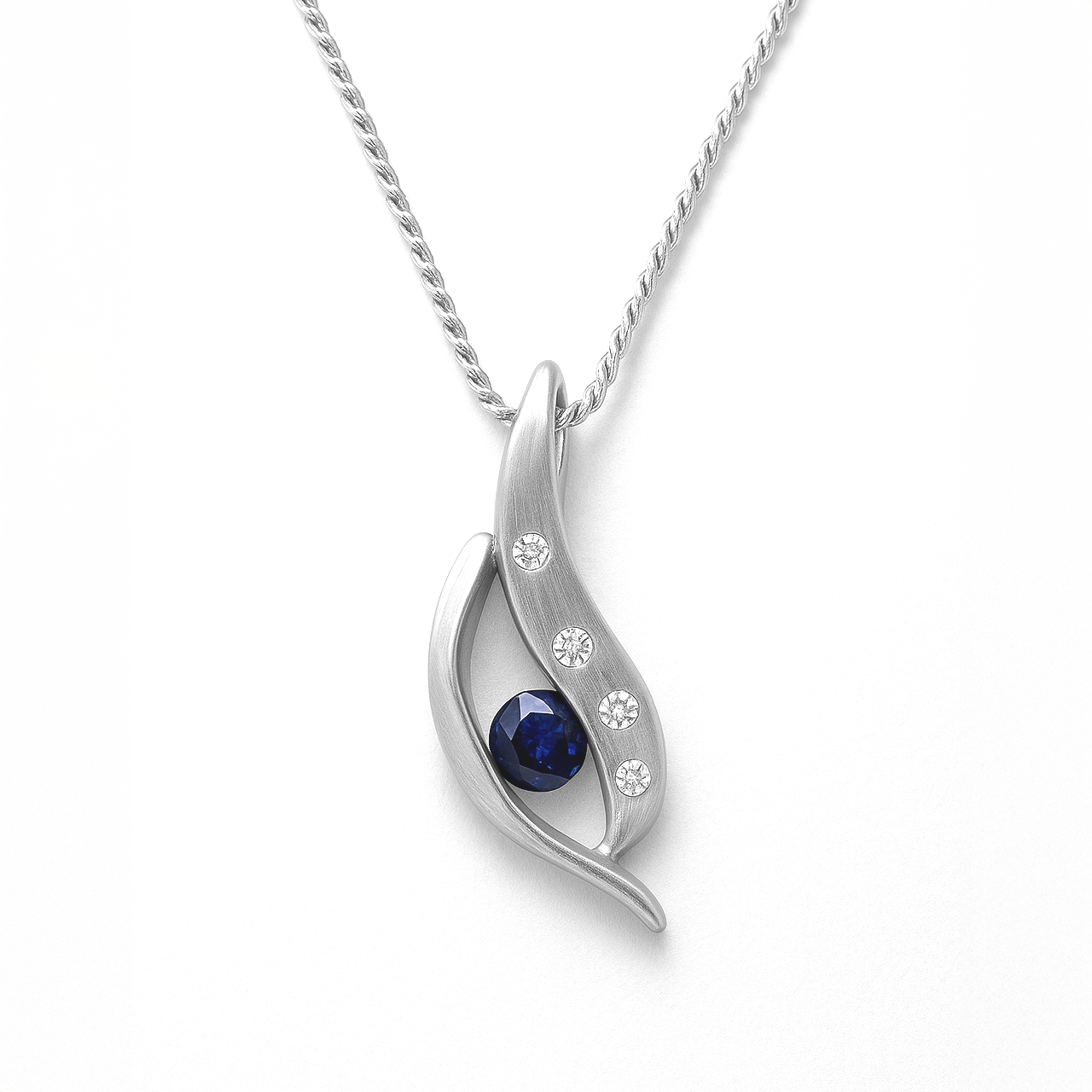 Silver pendant with a blue gemstone on a white background