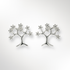 Silver tree-shaped earrings on a light grey background