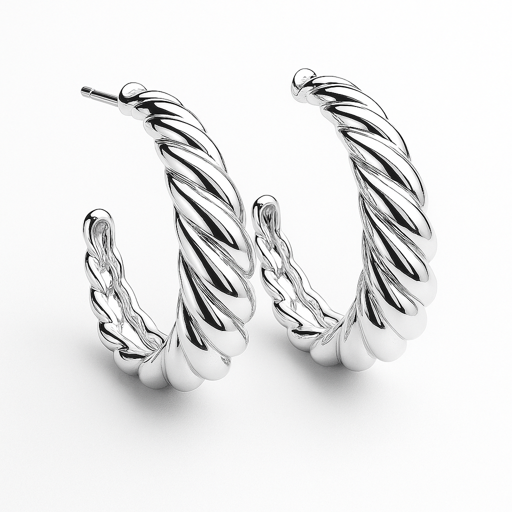 Silver hoop earrings with twisted design on a white background