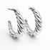 Silver hoop earrings with twisted design on a white background