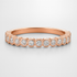 Rose gold wedding ring with diamonds on a light grey background