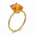 Gold ring with a large orange gemstone on a white background