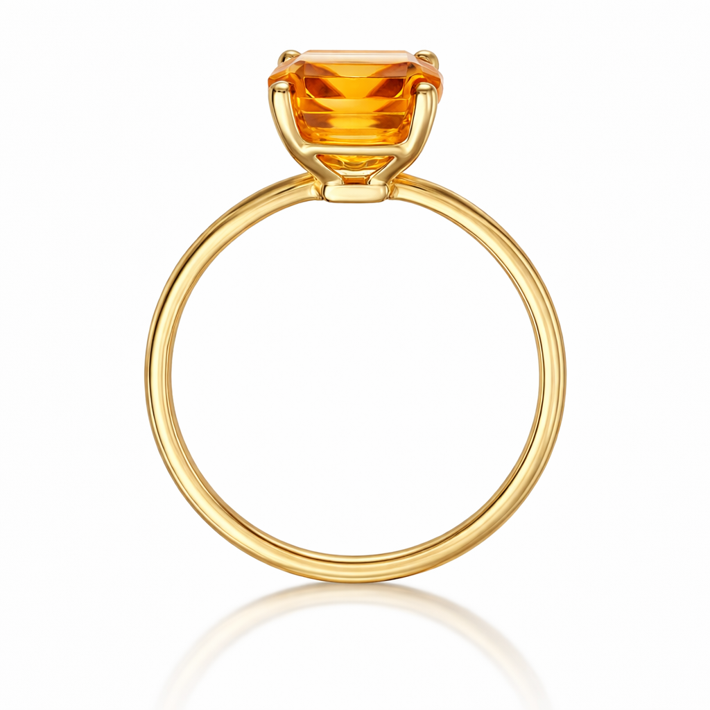 Gold ring with a large orange gemstone on a white background